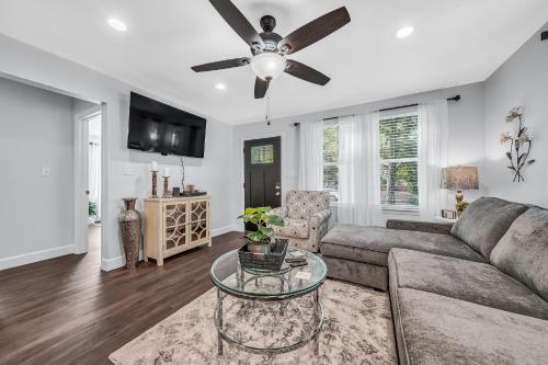 a living room with a couch and a ceiling fan at The Green Emerald in Brenham