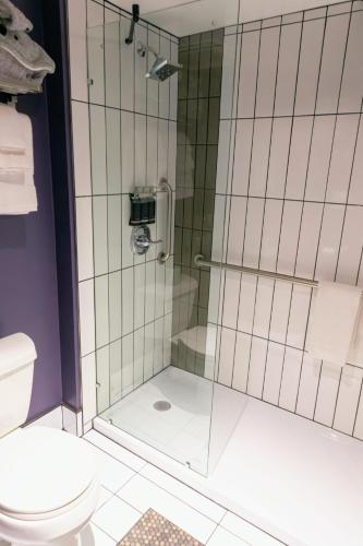 a bathroom with a shower and a toilet at Silverbow Inn in Juneau