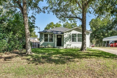 a house with trees in front of it at The Green Emerald in Brenham
