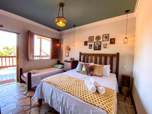 a bedroom with two beds with towels on them at Bica D' Água Boutique Hotel in Capitólio