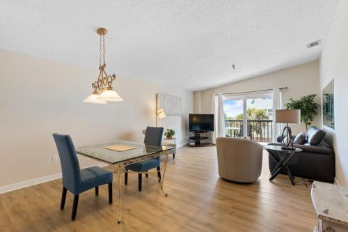a living room with a dining room table and a couch at 346 Surf Song Resort in St Pete Beach