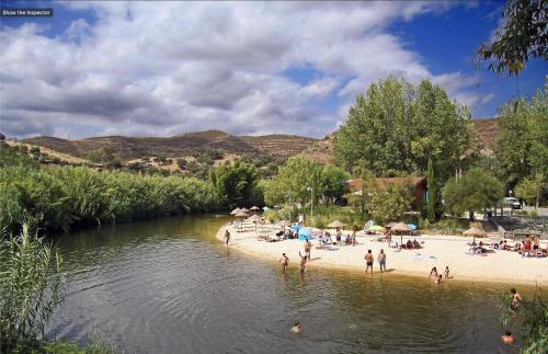 a group of people on a beach next to a river at Charming Countryside Home with Fireplace & Patio in Alcoutim