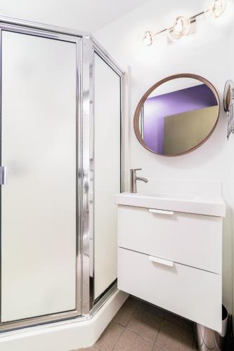 a bathroom with a mirror and a sink at Silverbow Inn in Juneau
