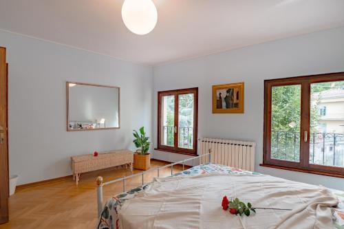 1 dormitorio con 1 cama en una habitación con ventanas en Il Nido sul Po, en Casalmaggiore