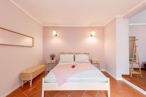 a bedroom with a white bed and a ladder at Il Nido sul Po in Casalmaggiore