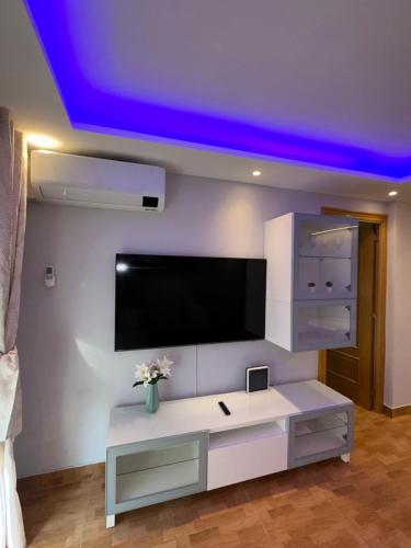 a living room with a tv on the ceiling at Apartamento Zaragoza Picarral in Zaragoza