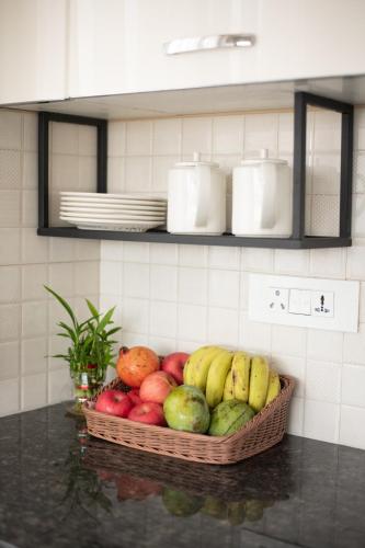 a basket of fruit on a counter in a kitchen at Mila Hotel in Kathmandu