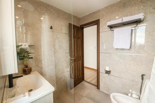 a bathroom with a sink and a toilet and a shower at Mila Hotel in Kathmandu