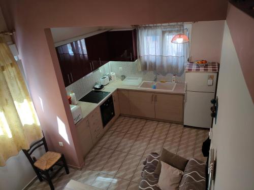 a small kitchen with a sink and a refrigerator at Modern House in Mytilene Center in Mytilini