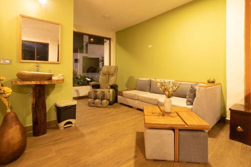 a living room with a couch and a sink at El Guayabal de Mindo in Mindo
