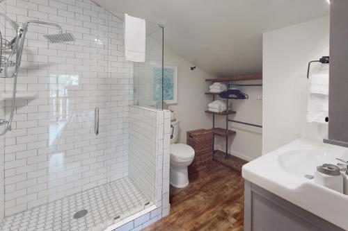 a bathroom with a shower and a toilet and a sink at Tahoe Tyrol Chalet in South Lake Tahoe