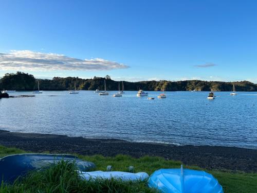 a large body of water with boats in it at Tutukaka Sunrise in Tutukaka