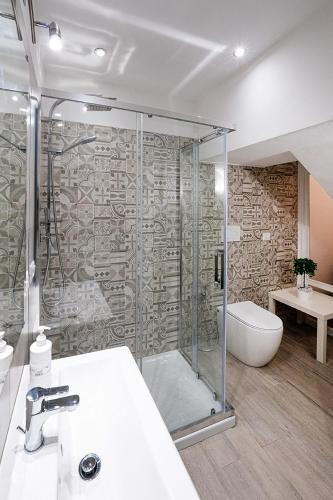 a bathroom with a shower and a sink and a tub at Casa Pirri in Castelmola