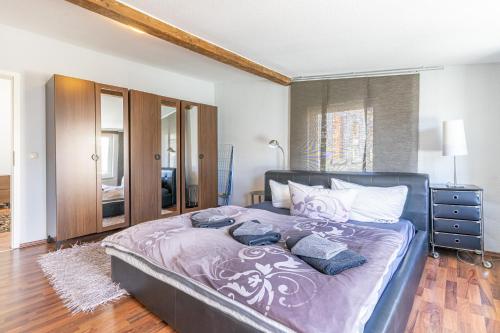 Schlafzimmer mit einem Bett mit lila Bettwäsche und Kissen in der Unterkunft Sassnitz - Ferienwohnung 3 im Appartementhaus Hafenriff in Sassnitz