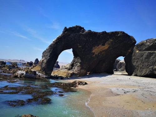 an arch in the rocks on the beach at HOTEL D'PIERO MARCONA in San Juan de Marcona