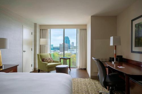 a hotel room with a bed and a desk and a window at Atlanta Marriott Perimeter Center in Atlanta