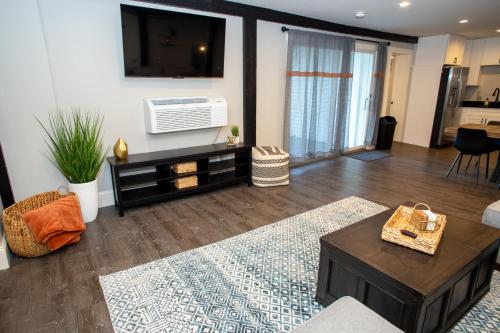 a living room with a flat screen tv on a wall at Gunstock Inn & Suites in Gilford
