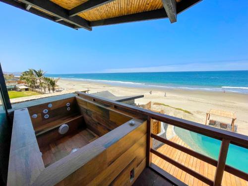 a balcony with a view of the beach at DIEM Vichayito Beachfront Eco-Luxury in Vichayito