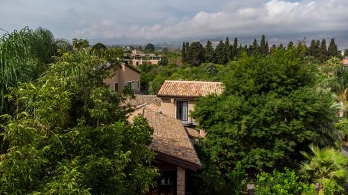 a group of houses in the middle of trees at Virdamuri - Etna Country Resort in Giarre