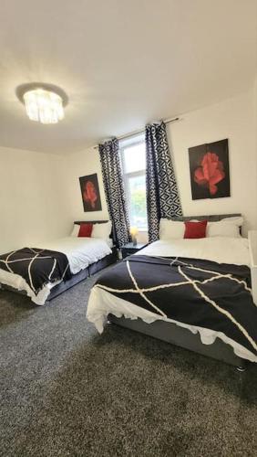 1 dormitorio con 2 camas y ventana en 4 Double Bedroom House in Accrington sleeps 6, en Accrington