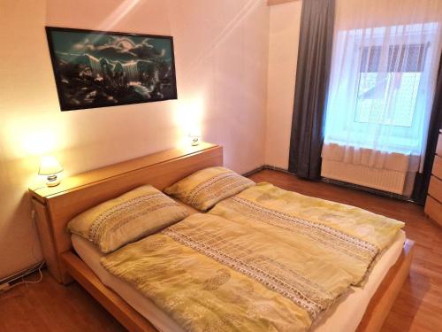 a bedroom with a bed with two pillows on it at Cosy apartment in Arnoldstein with garden in Arnoldstein