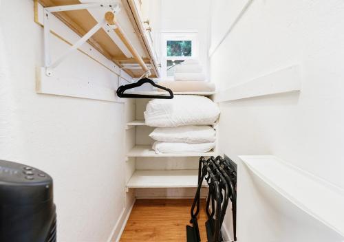 a small bathroom with white walls and white towels at Cozy Oceanside Retreat-Walk to Beach! in Oceanside