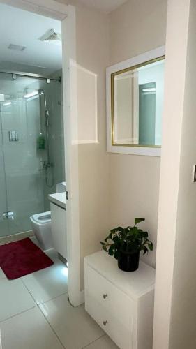 a bathroom with a shower and a toilet and a plant at 2 BR Kingston Lux Apt with pool - 106 in Kingston