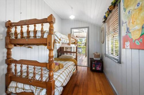 a bedroom with a bunk bed in a house at Buderim Milne House in Buderim