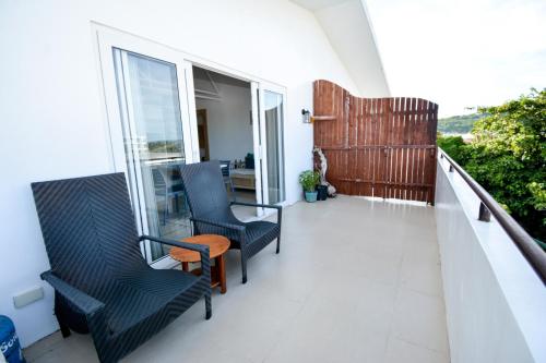 a balcony with two chairs and a table at Babosam Apartments in Boracay