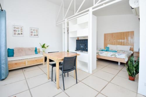 a room with a table and a bed and a bedroom at Babosam Apartments in Boracay