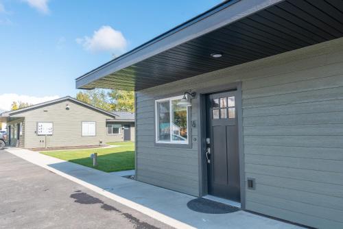 a gray house with a door on the side of it at Colony Suites in Palmer