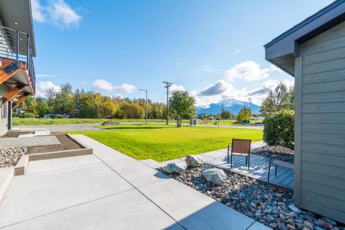 a walkway in front of a house with a lawn at Colony Suites in Palmer
