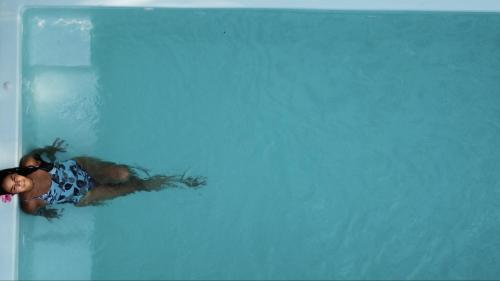 una mujer flotando en una piscina en Casa Amazonas, en Puerto Maldonado