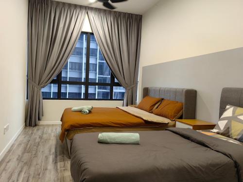 a bedroom with two beds and a large window at Millerz Square Mid Valley, Old Klang Road in Kuala Lumpur