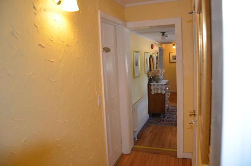 a hallway of a home with a yellow wall at Cornwall Inn in Cornwall Bridge
