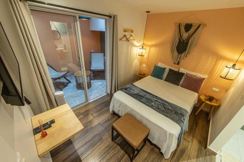 a small room with a bed and a balcony at La Martina Boutique Hotel in Medellín