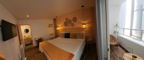 a hotel room with a bed and a window at La Martina Boutique Hotel in Medellín