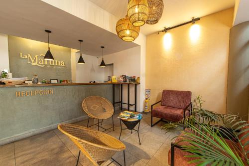 a waiting room with chairs and a counter in a store at La Martina Boutique Hotel in Medellín