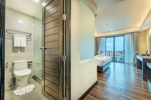 a bathroom with a toilet and a bathroom with a bedroom at Treepana Boutique Hotel, Huahin in Hua Hin