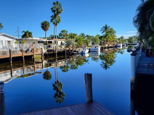 a body of water with palm trees and boats at 4 bd Near beach spacious solar heated pool waterfront home in Pompano Beach