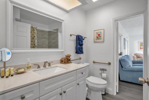 a white bathroom with a sink and a toilet at Purely Pompano, Pool, Water front, Paddleboard, Beach, 5 bedroom 3 bath in Pompano Beach