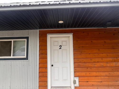 a house with a white door with the number on it at Studio apartment in Cranbrook