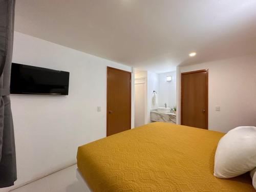 Postel nebo postele na pokoji v ubytování Hotel Quinta Luna Zacatlán