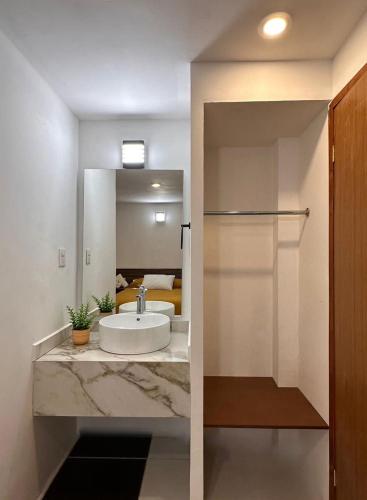 a bathroom with a sink and a mirror at Hotel Quinta Luna Zacatlán in Zacatlán