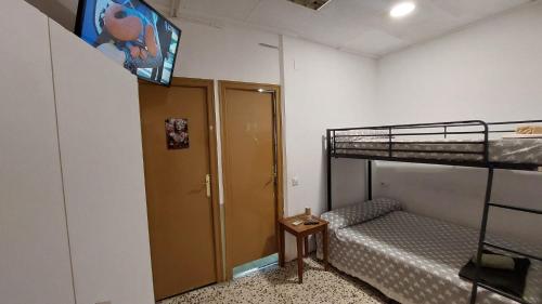 Mały pokój z łóżkiem piętrowym i łóżkiem piętrowym w obiekcie Pension Suiza w mieście Reus