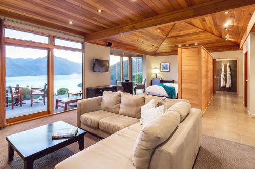 
a living room filled with furniture and a large window at Azur Lodge in Queenstown
