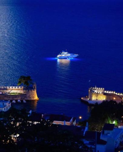 a cruise ship in the ocean at night at Casa da Sogno Elegant Studio in Nafpaktos