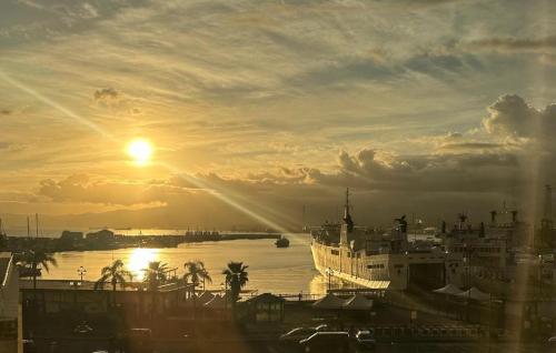 a boat is docked in a harbor at sunset at B&B Varadero in Milazzo