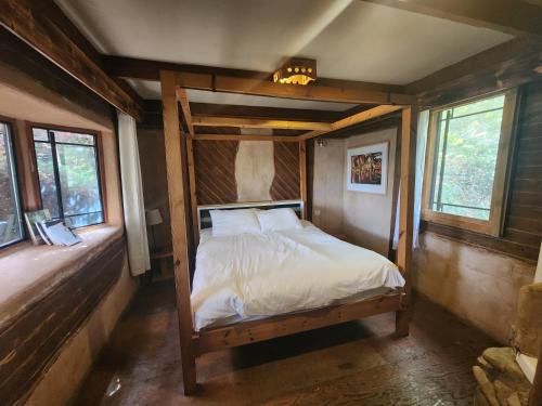 a bedroom with a bed in a room with windows at Biktot Ba Arafel in Nimrod