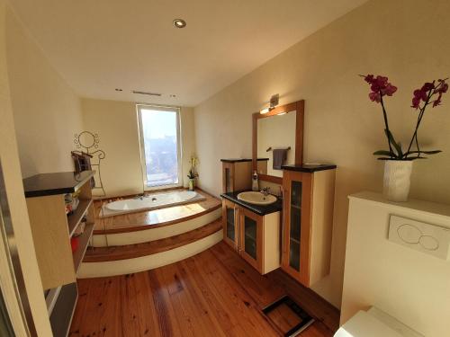 uma casa de banho com 2 lavatórios e uma banheira em Huize La Passion vacationhouse 10 min walk from the sea em Middelkerke